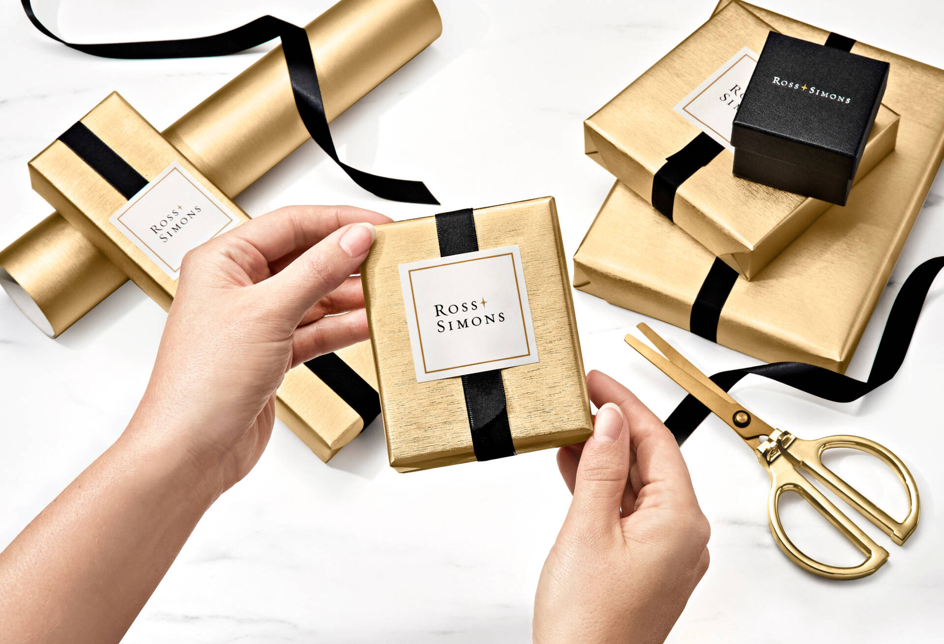 Hands holding gift wrapped boxes