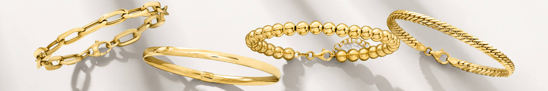 image featuring several styles of Italian gold bracelets