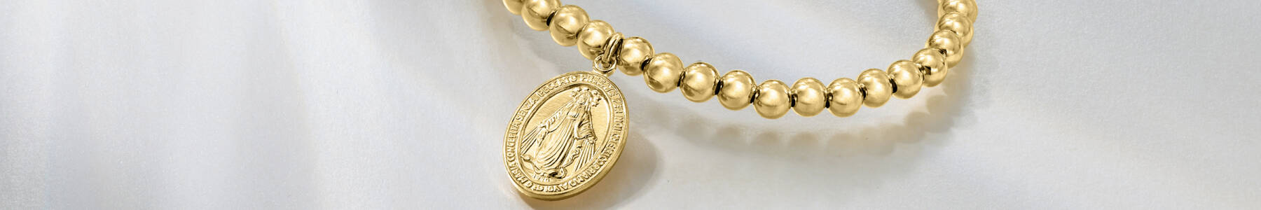 Religious Jewelry. Image featuring a bead bracelets with pendant