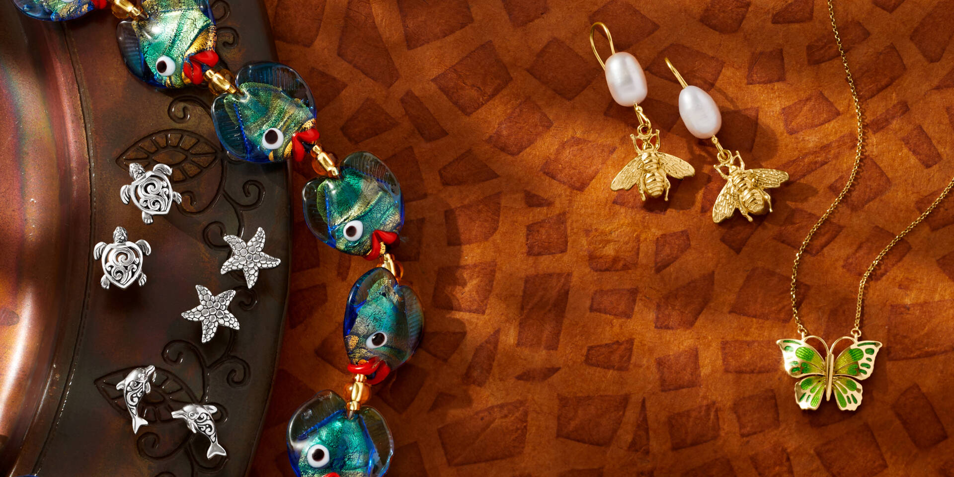 assorted jewelry with anmals like fish necklace, bee earring, butterfly necklace