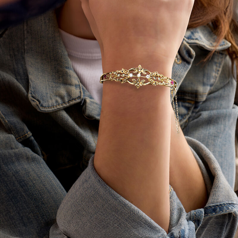 C. 1930 Vintage .35 ct. t.w. Diamond and .35 ct. t.w. Ruby Bangle Bracelet with Seed Pearls in 14kt Yellow Gold. 7" image number 1